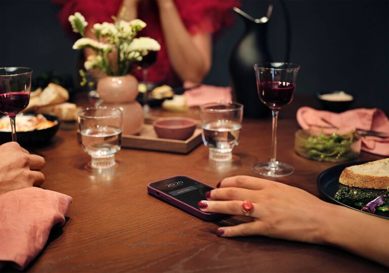 Personnes attablées avec un téléphone